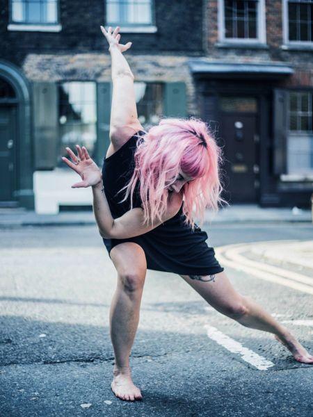 Woman dancing in the street - positive image library