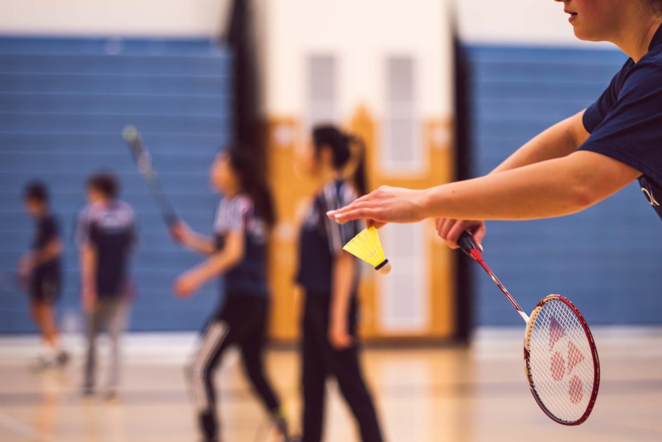 Young people playing badminton