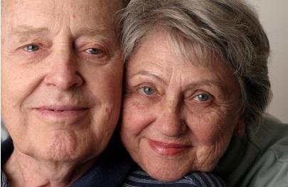 Elderly couple smiling at the camera