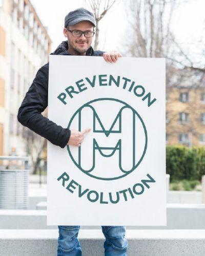 Man holding MHF prevention sign