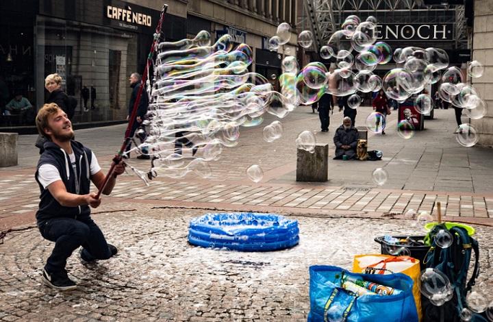 Image of a street artist blowing bubbles