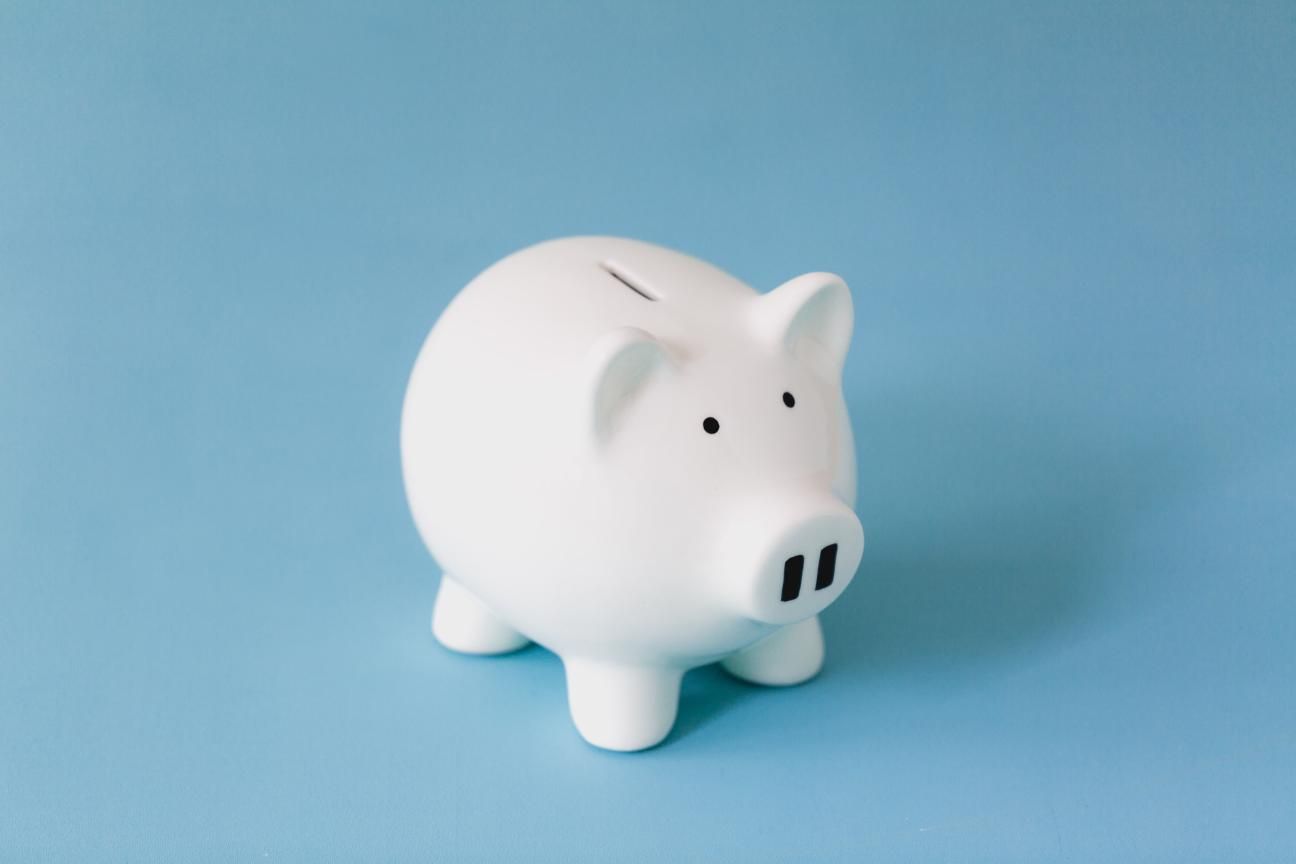 White piggy bank for collecting money on a blue background