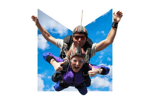 Skydivers in front of an M-shaped blue sky background