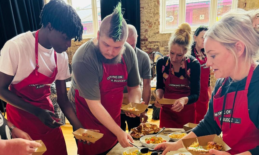 A group of people wearing aprons and sharing food together