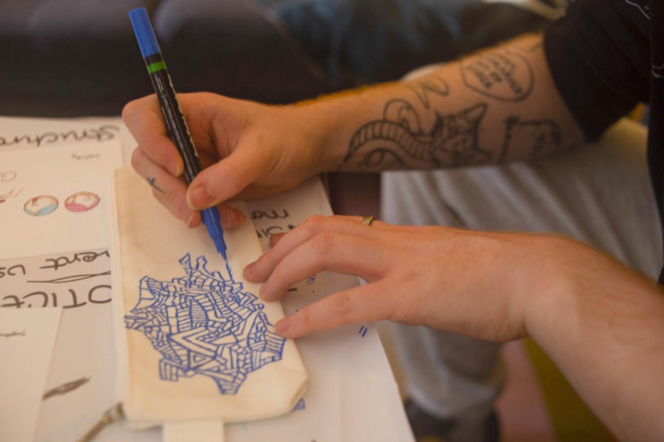 hands drawing and colouring on paper