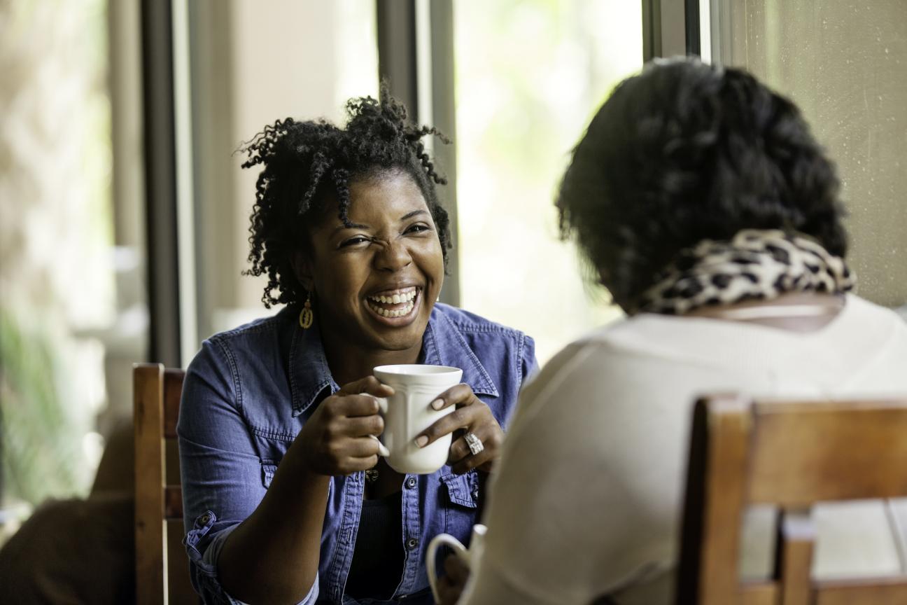 Two women chat over coffee