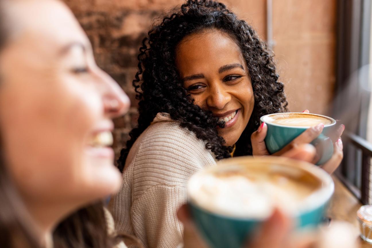 Two friends drink coffee