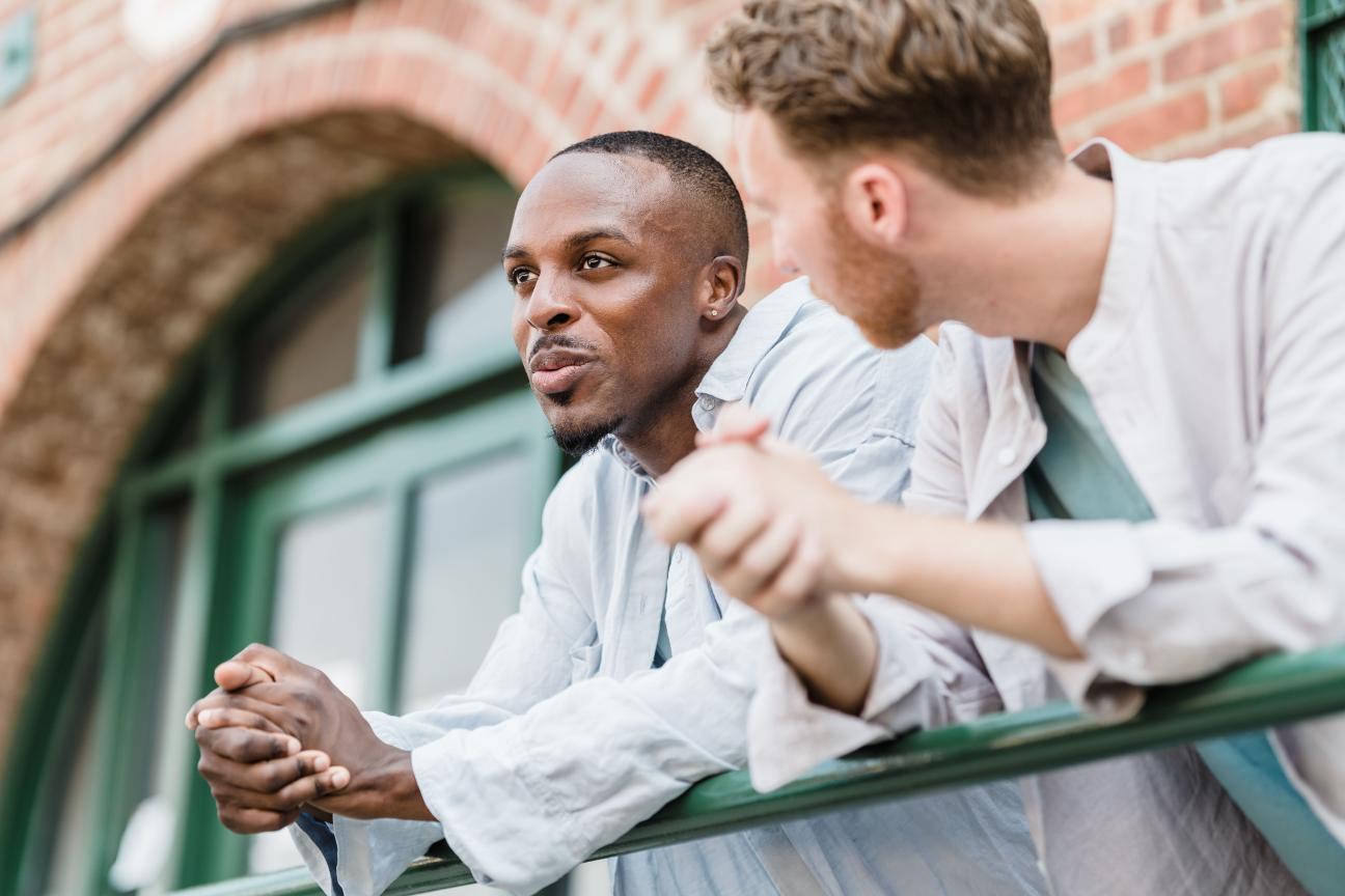Two guys having a conversation outside