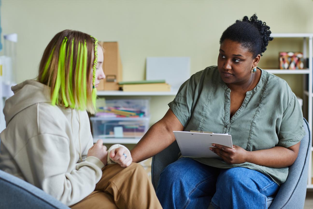 A woman comforting a young person