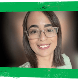 Huma smiling at the camera with a green frame around the image