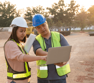 Two workers viewing plans on building site