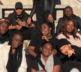 A group of university students sitting on some stairs