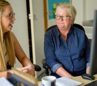 Two women talking at work