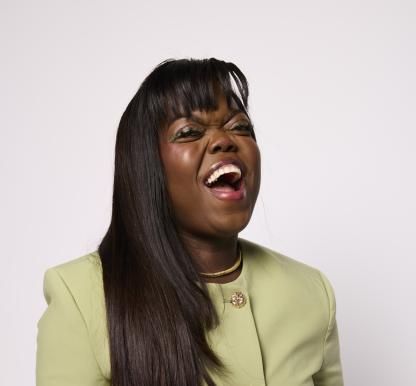 Fats Timbo laughing and wearing green dress