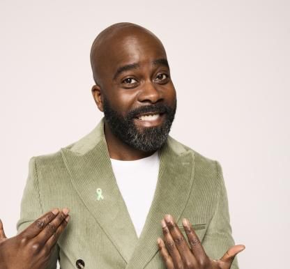 Melvin Odoom wearing green suit 