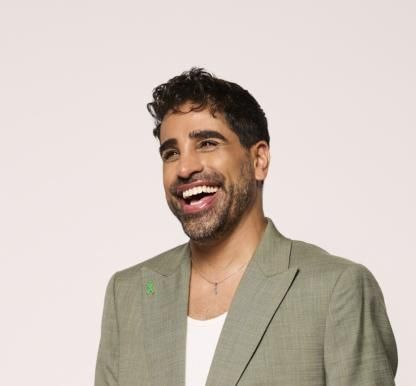 Dr Ranj Singh wearing a green suit