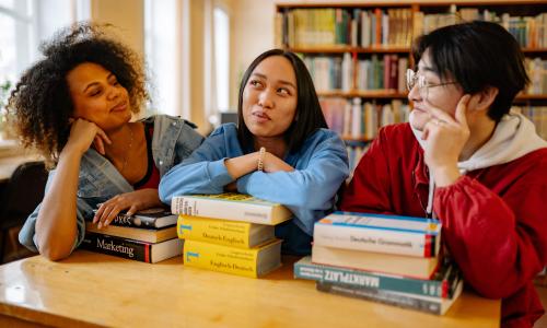 A group of university students studying at a table