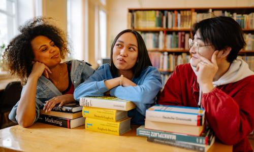 A group of university students studying at a table