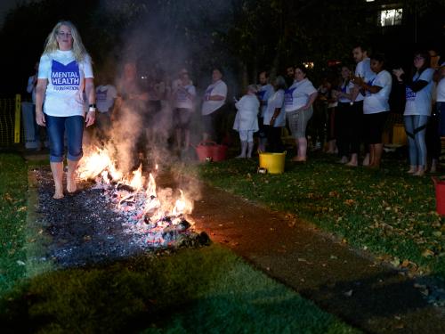 Person completing firewalk in London