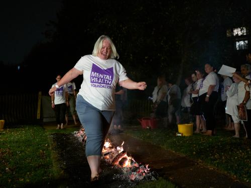 Person completing firewalk, London 2025