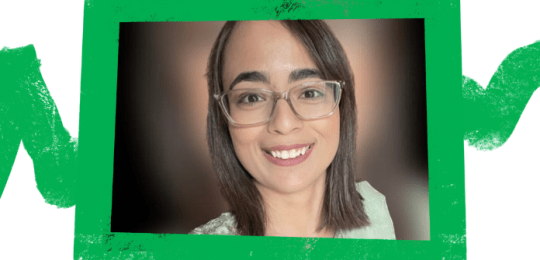 Huma smiling at the camera with a green frame around the image