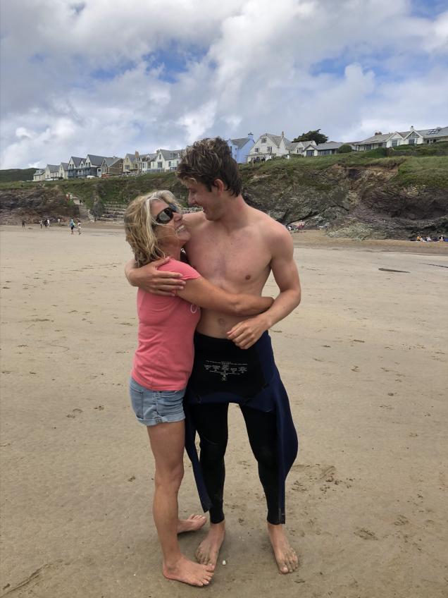 Photo of Ben with his mum at the beach