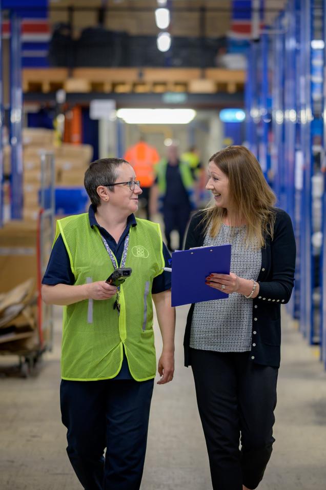 Two women working in a warehouse or a factory