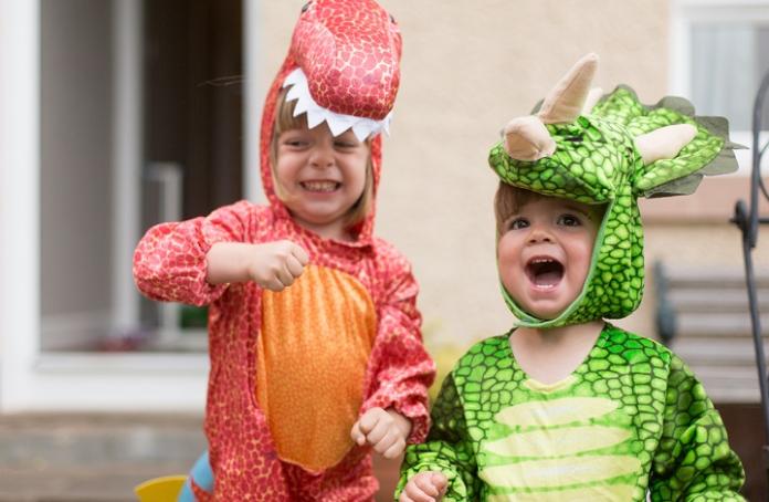Image of two little kids dressed up as dinosaurs