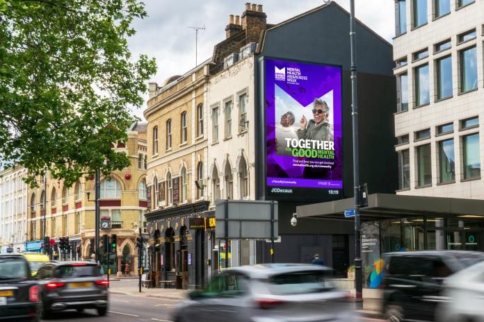 Mental Health Awareness Week Advert on a billboard on a busy street