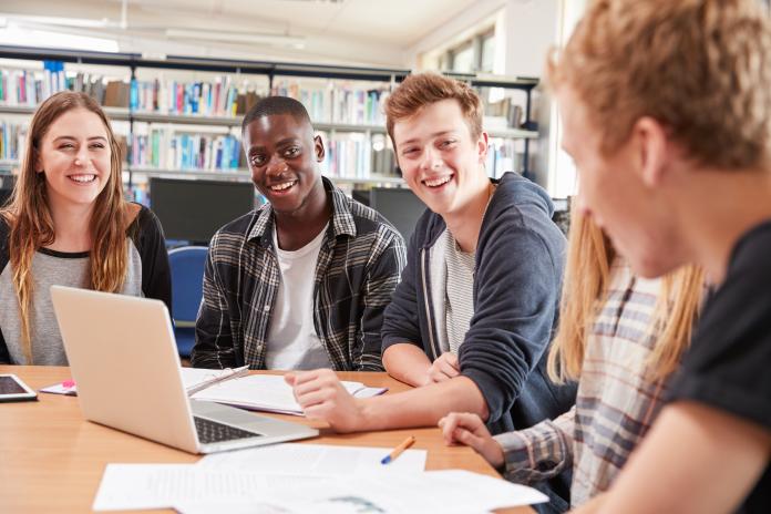 A group of students sitting at a table studying