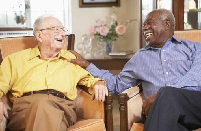 Photo of two older men laughing together