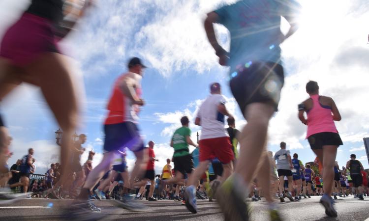 Image of people running past quickly