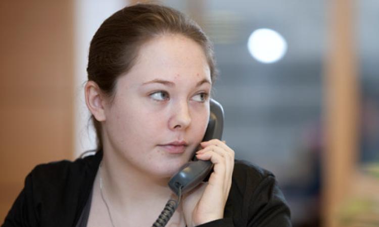 A young woman on an office phone