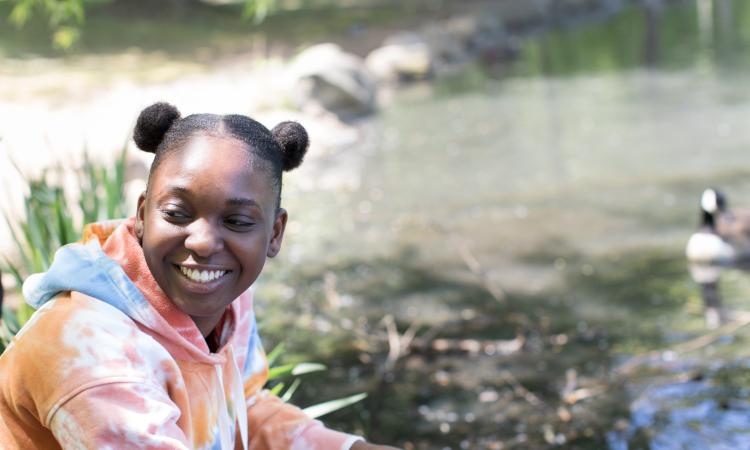 Photo of a child enjoying nature at a lake