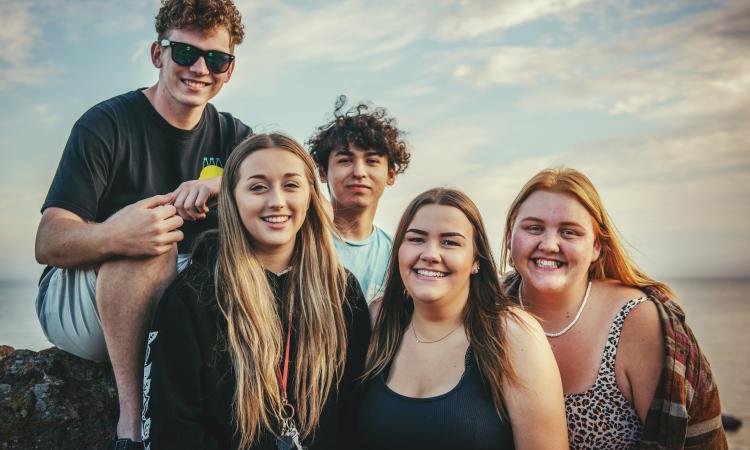Group of young people smiling outside