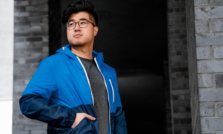 Young man outside in a blue jacket