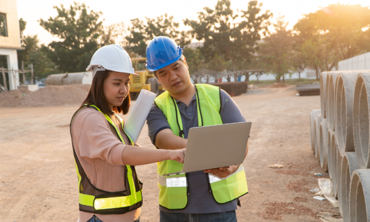 Two workers viewing plans on building site