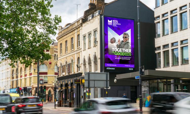Mental Health Awareness Week Advert on a billboard on a busy street