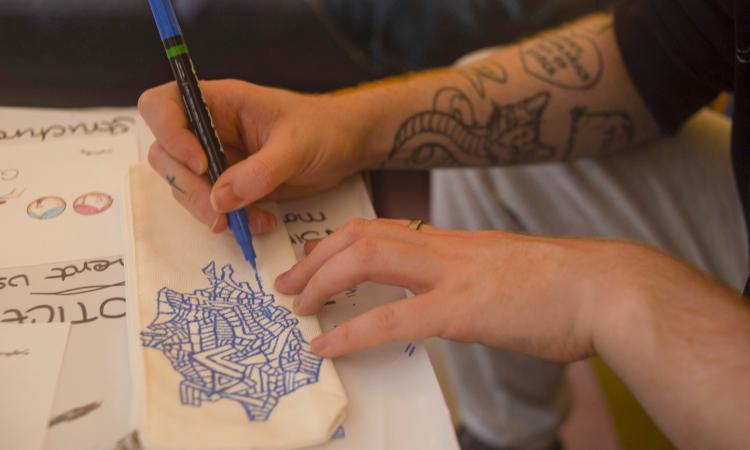 hands drawing and colouring on paper