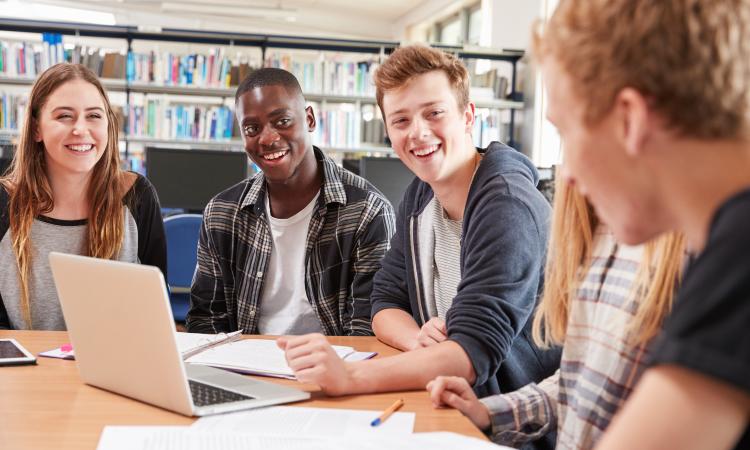A group of students sitting at a table studying