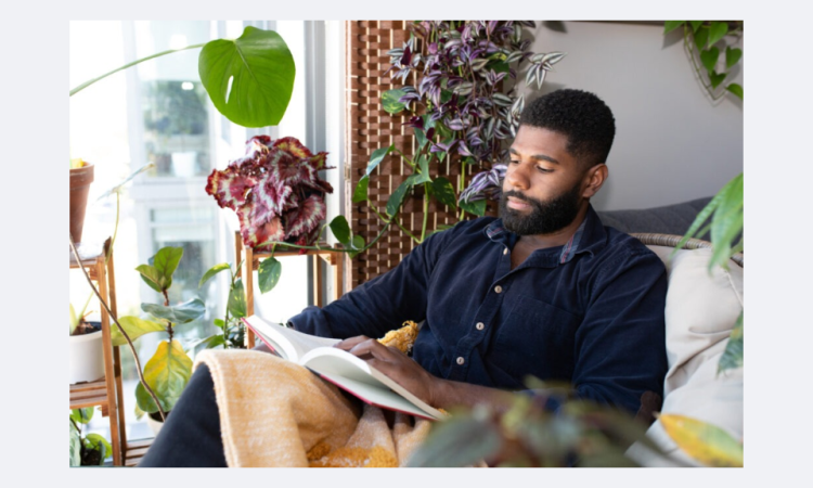 man sitting in room with plants