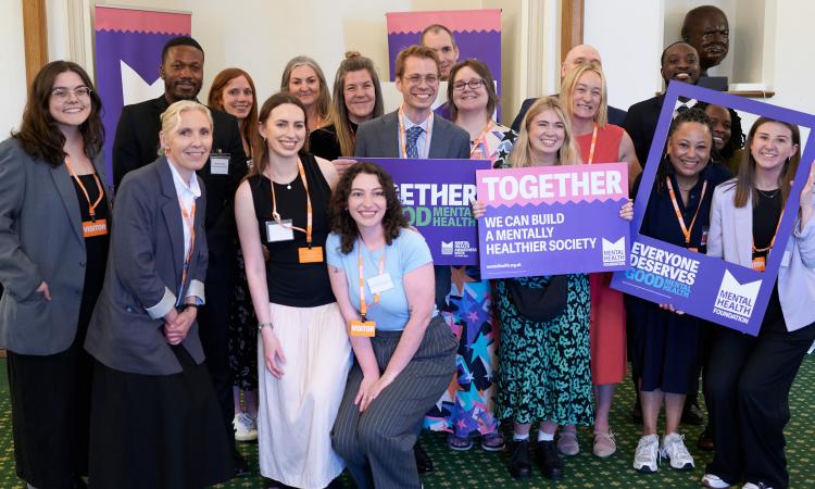 The Mental Health Foundation team standing in a group during our reception event at the Houses of Parliament during Mental Health Awareness Week