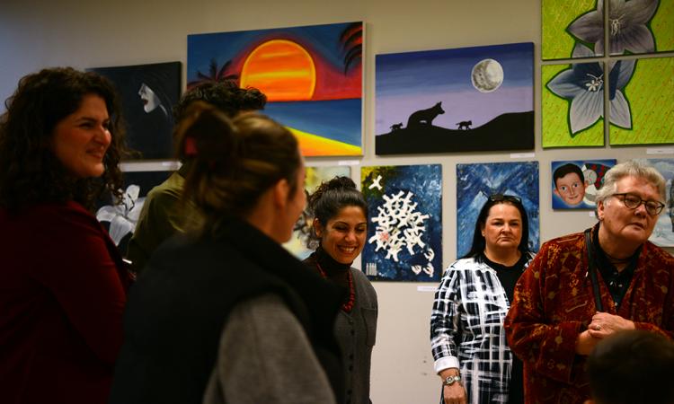 People smiling at art exhibition 