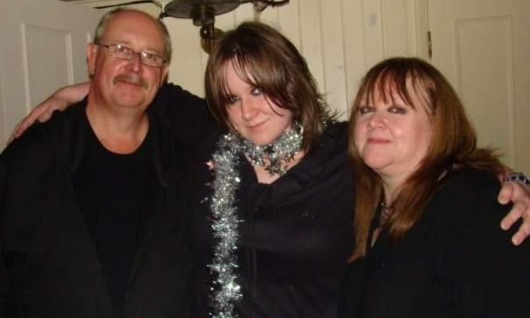 Image of Nicola with her parents at a party