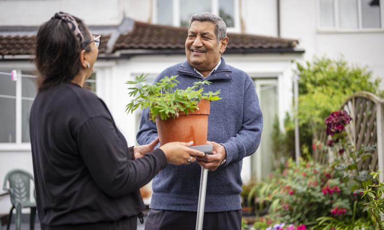 Couple outside talking in their garden
