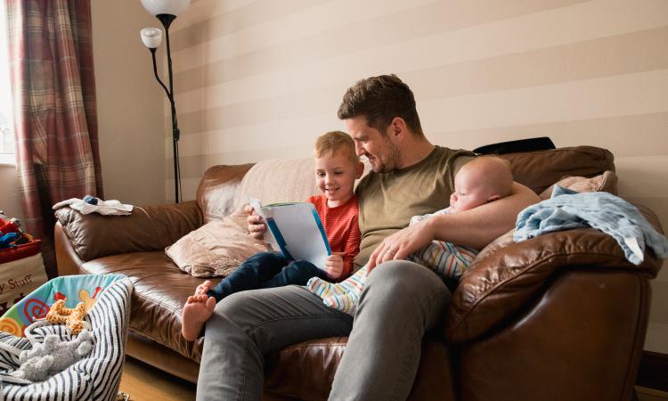 Father with two young children sitting at home