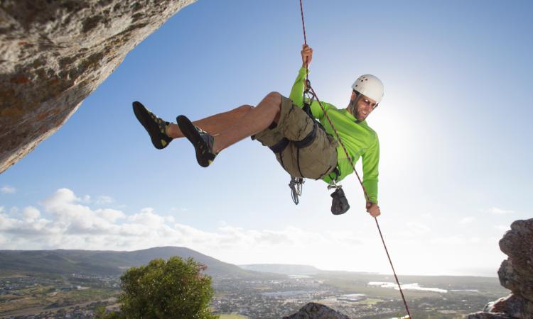 Man abseiling down cliff face
