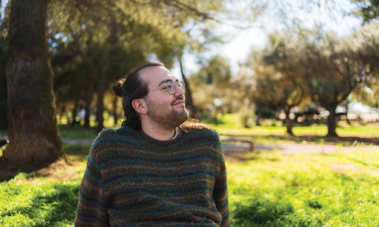 Man sitting outside in nature during the summer