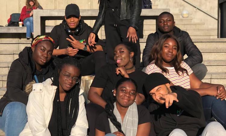A group of university students sitting on some stairs