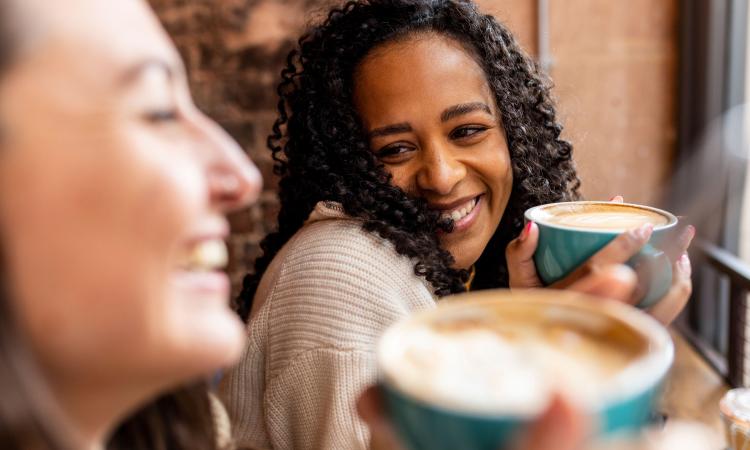 Two friends drink coffee